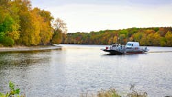 A Glastonbury Ferry crosses the water. A Glastonbury Ferry crosses the water.