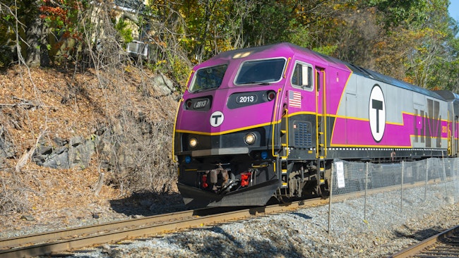An MBTA Commuter Rail trains moves along the track.
