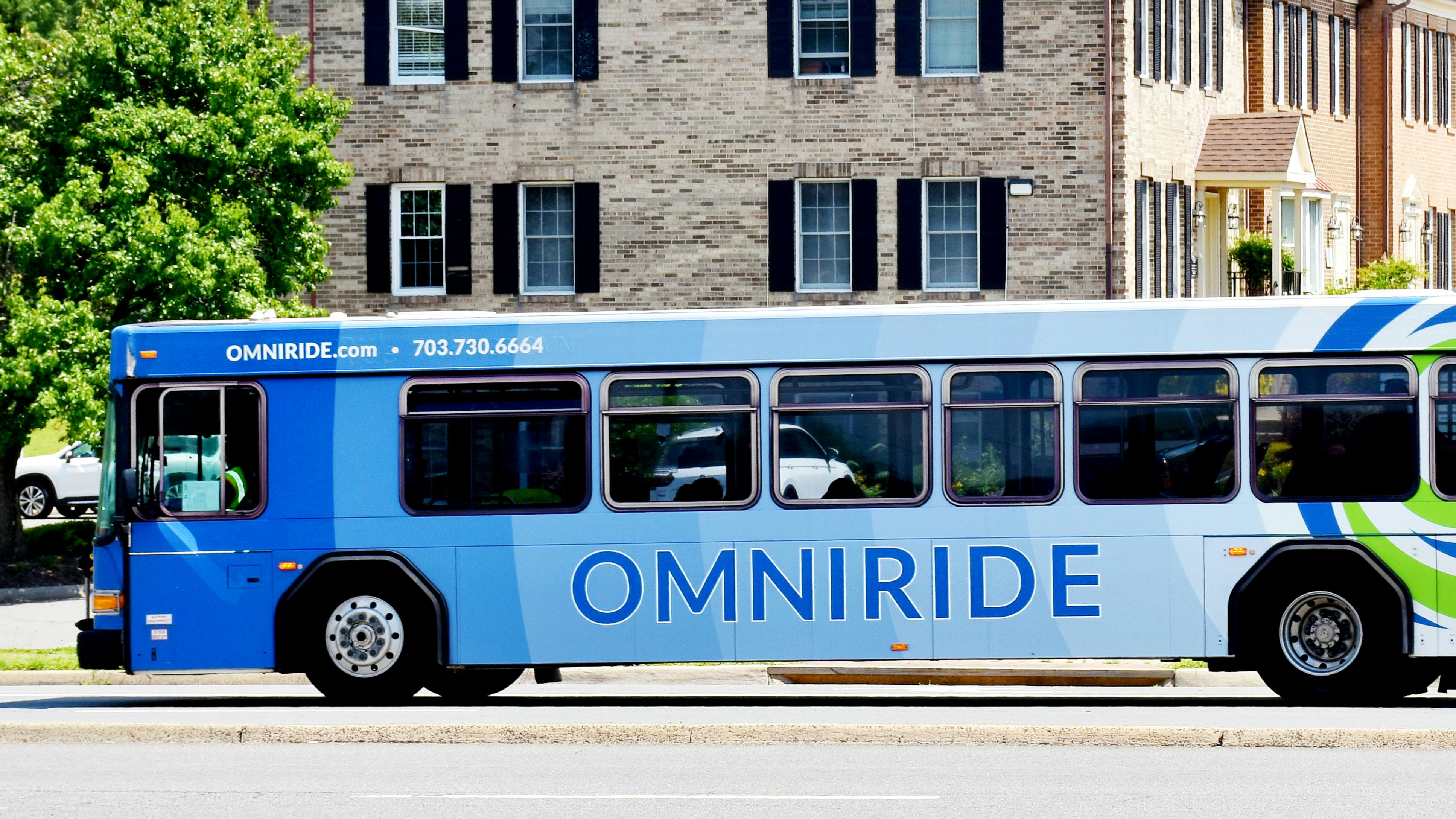 An OmniRide bus drives down the street.
