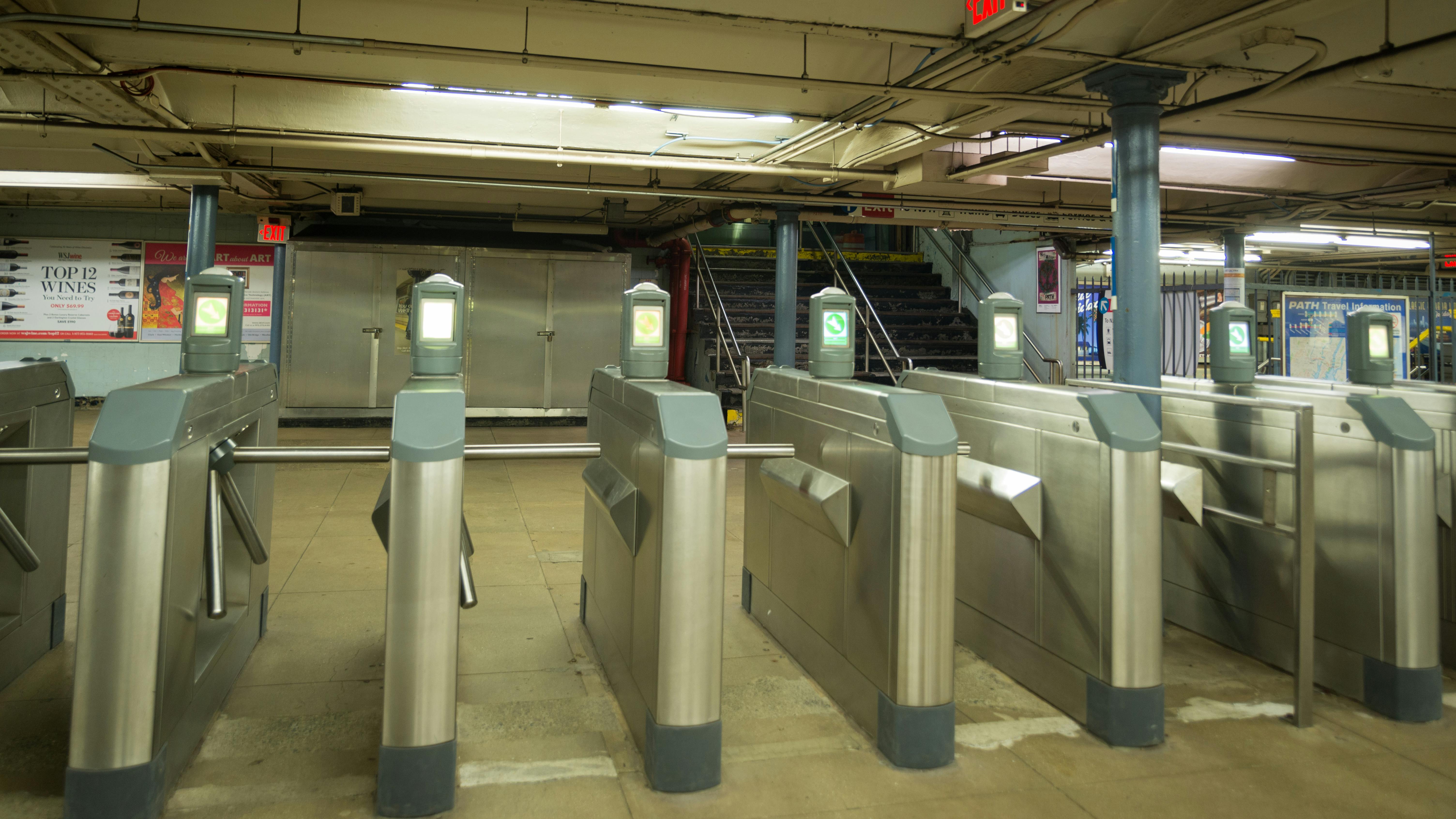 The image shows PATH turnstiles.