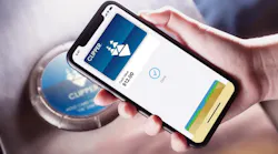 A rider taps a Clipper Card from the Apple Wallet on an iPhone.