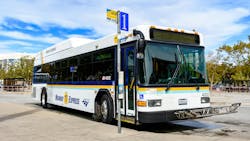 A bus sits at a San Jose stop. A bus sits at a San Jose stop.