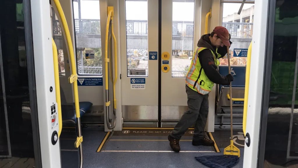 TriMet cleaning staff cleans a light-rail vehicle.