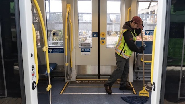 TriMet cleaning staff cleans a light-rail vehicle.