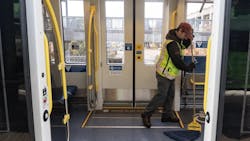 TriMet cleaning staff cleans a light-rail vehicle. TriMet cleaning staff cleans a light-rail vehicle.