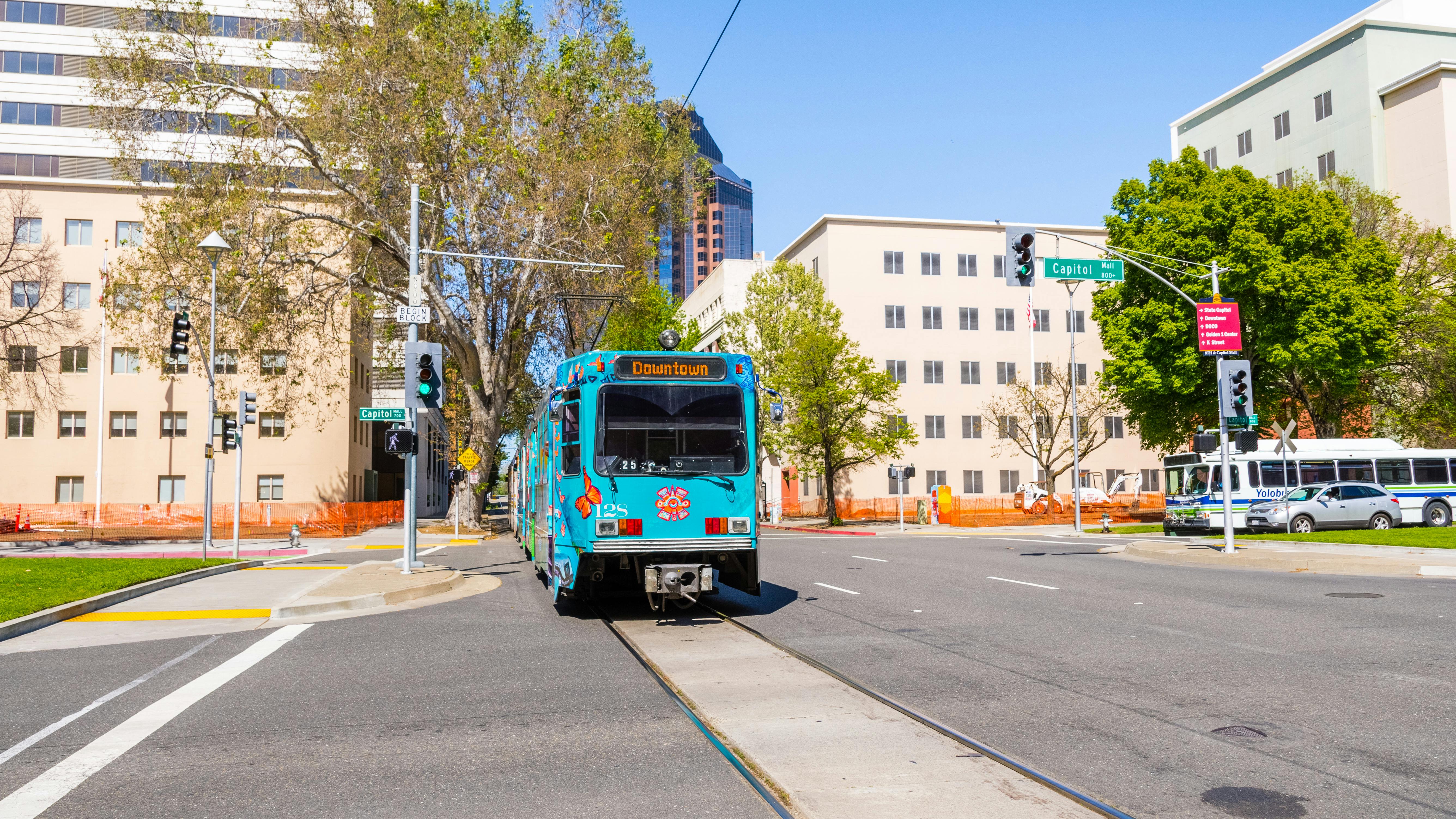 The image shows a Blue Line LRT moving down the track.