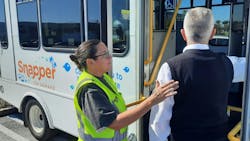 An operator helps a passenger onto The Snapper. An operator helps a passenger onto The Snapper.