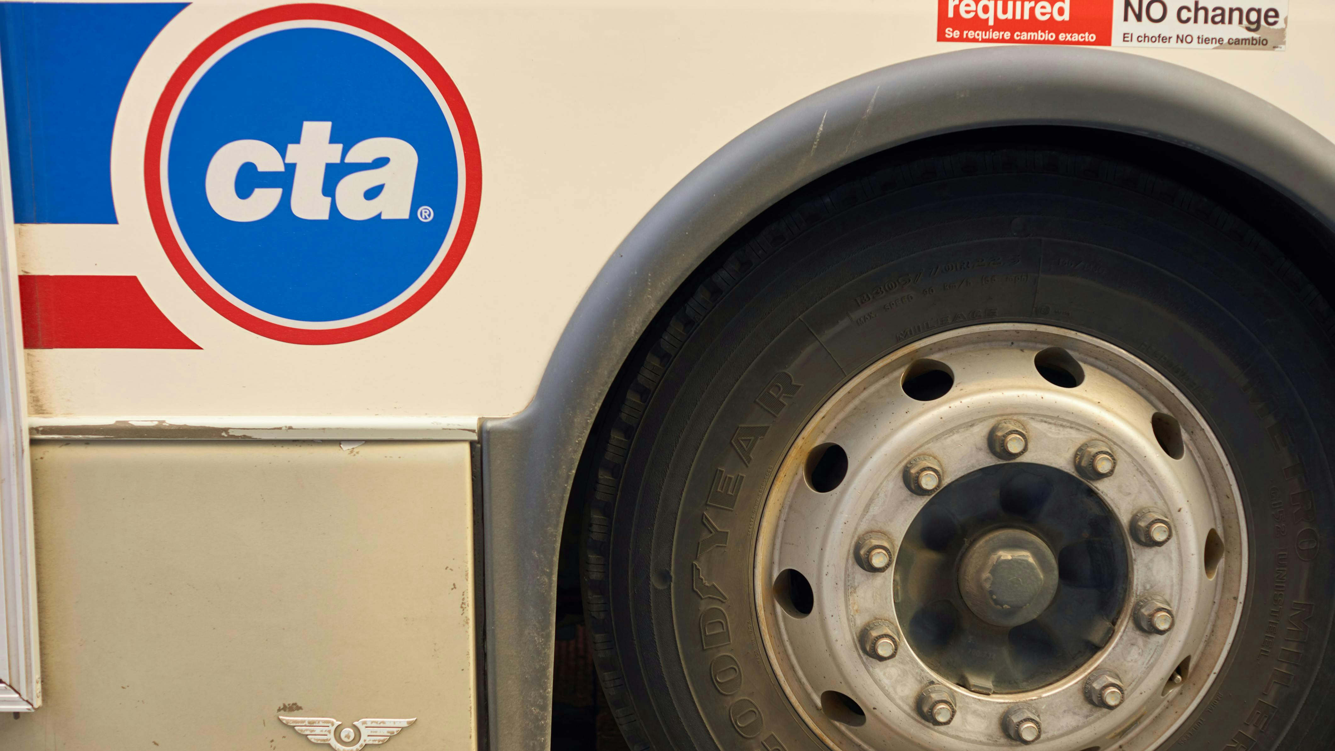 The image displays a close up shot of a wheel well of a CTA bus displaying the CTA logo.