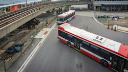 The image shows two TTC buses entering a transit center. The image shows two TTC buses entering a transit center.