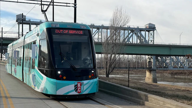 A new streetcar moves down the track.
