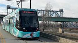 A new streetcar moves down the track.