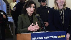 New York Gov. Kathy Hochul stands at a lectern speaking. New York Gov. Kathy Hochul stands at a lectern speaking.