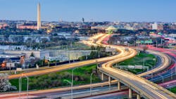A long-exposure shot of the Washington D.C. area with traffic moving through the streets. A long-exposure shot of the Washington D.C. area with traffic moving through the streets.