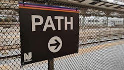 The image displays a sign for PATH train service. The image displays a sign for PATH train service.