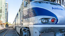 An Amtrak train waits to exit a station.