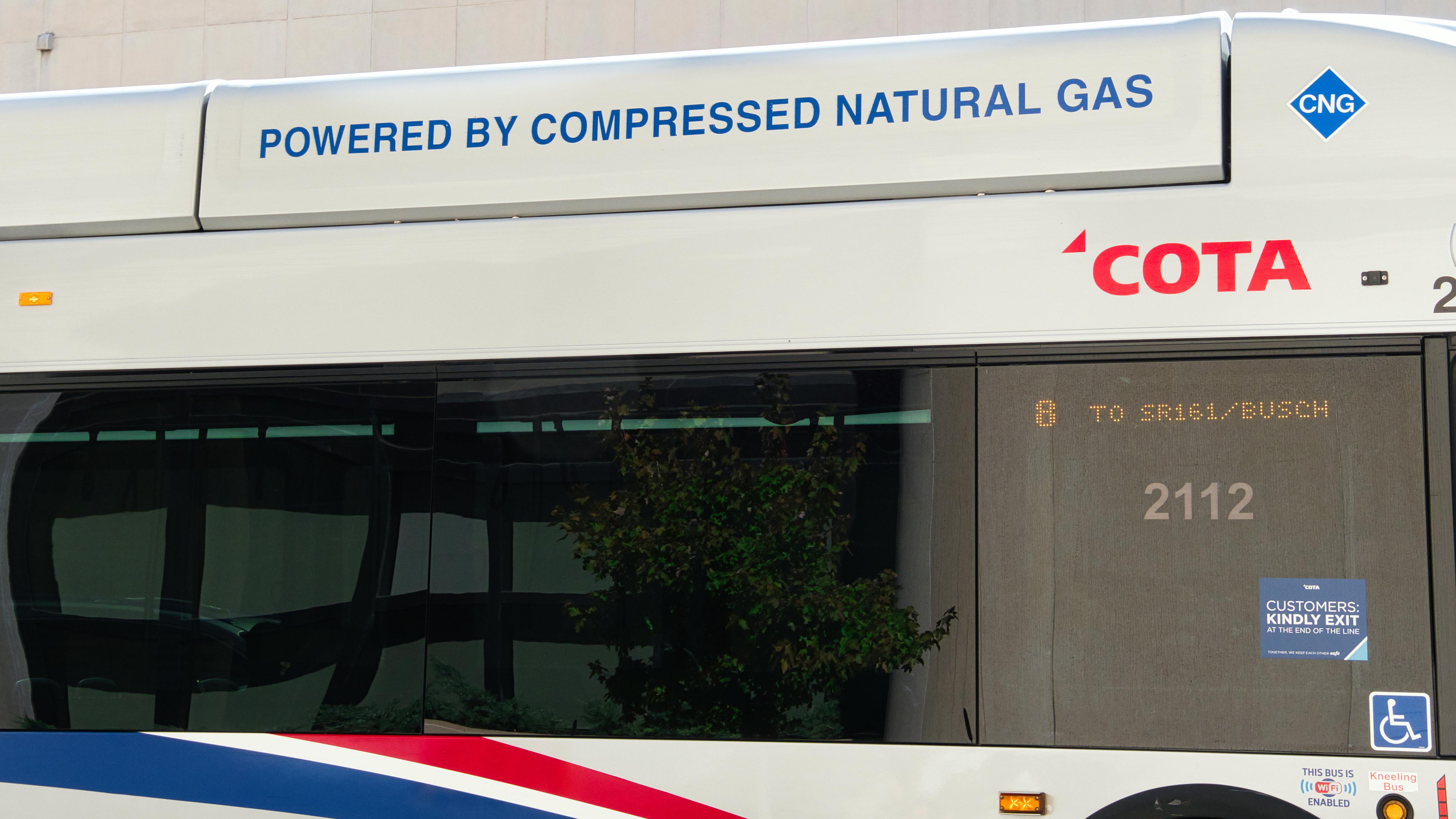 The image shows a close up shot of a COTA logo on a bus.