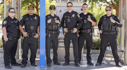 Officers that will patrol SacRT transit services stand in front of a ticket vending area.