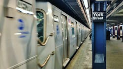 An MTA subway car passes by in a blurred photo. An MTA subway car passes by in a blurred photo.