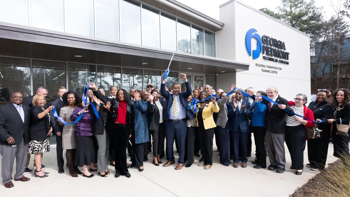 College leaders stand in front of the newly opened transit training center.