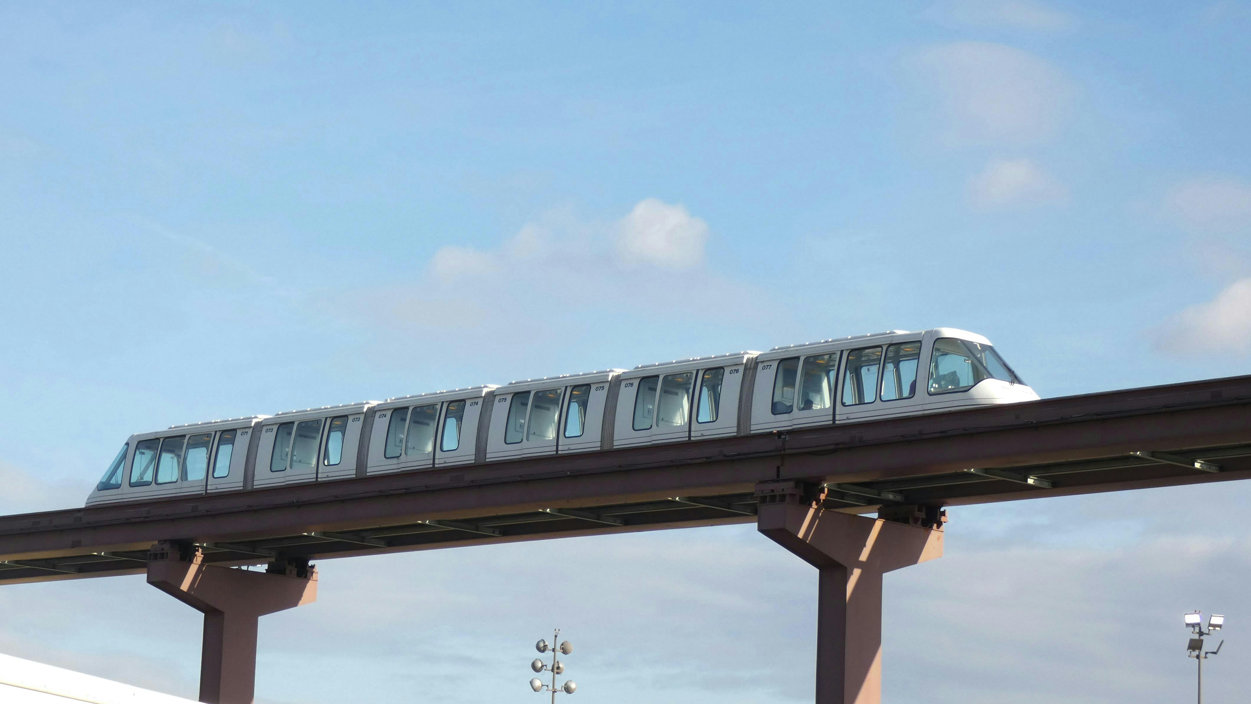An AirTrain moves along the track.