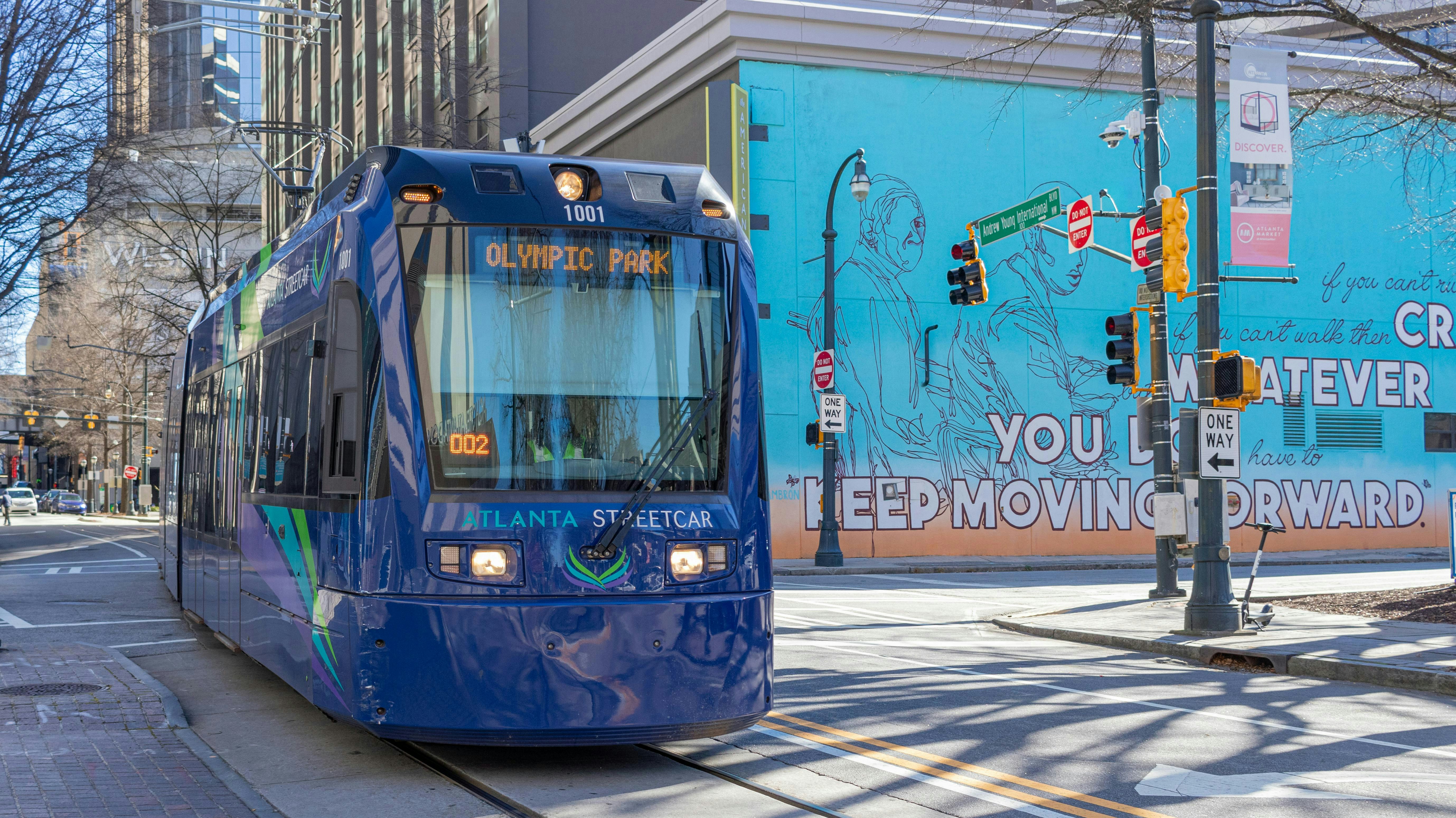 A streetcar moves down the track through the city.
