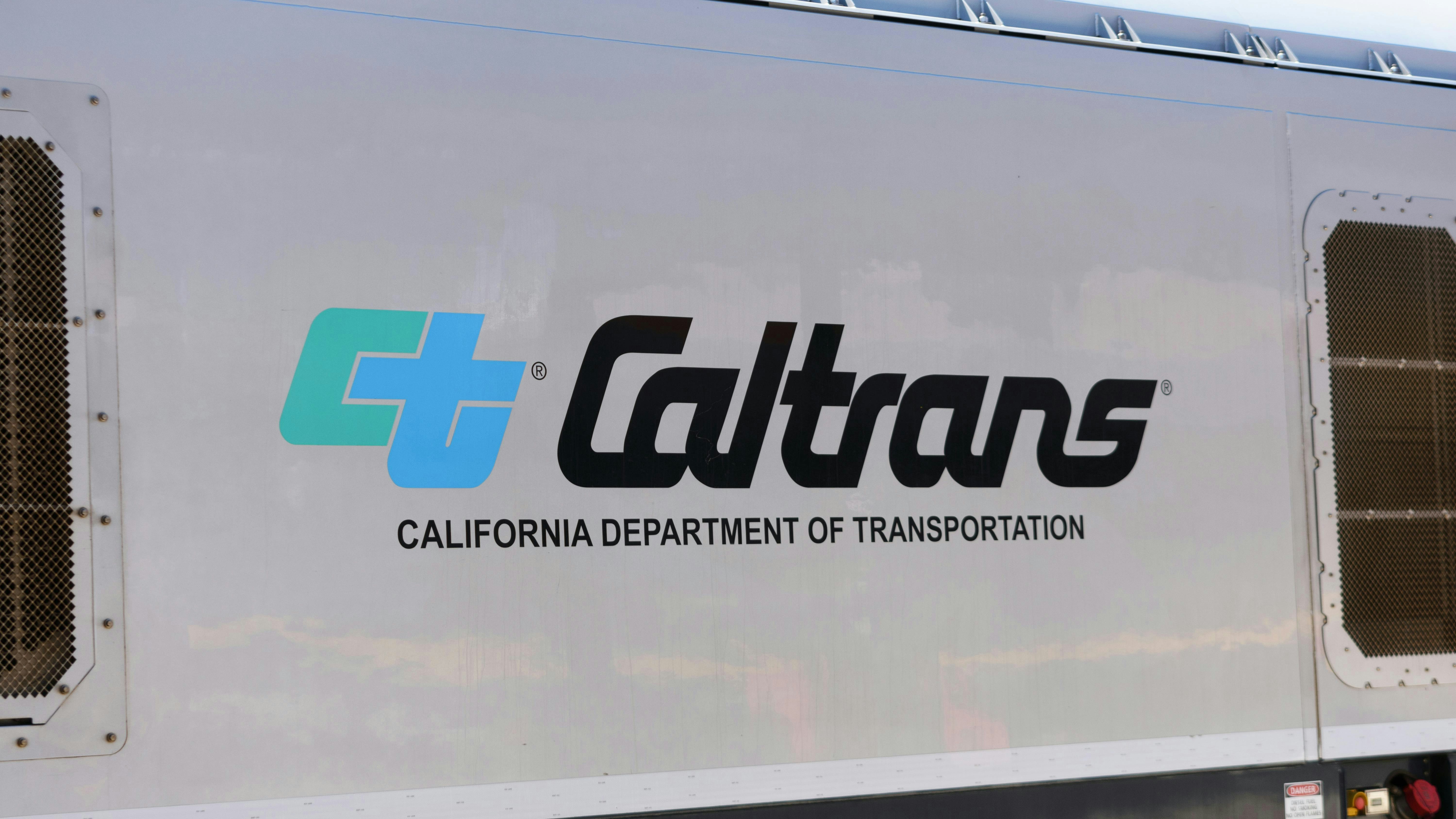 The Caltrans logo is shown on the side of a transit vehicle.