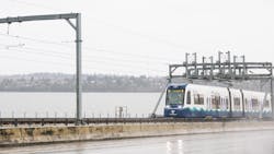 A Sound Transit light-rail vehicle crosses water on a floating bridge. A Sound Transit light-rail vehicle crosses water on a floating bridge.