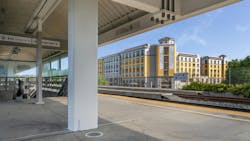 The image shows an exterior shot of the new building taken from a nearby transit platform. The image shows an exterior shot of the new building taken from a nearby transit platform.