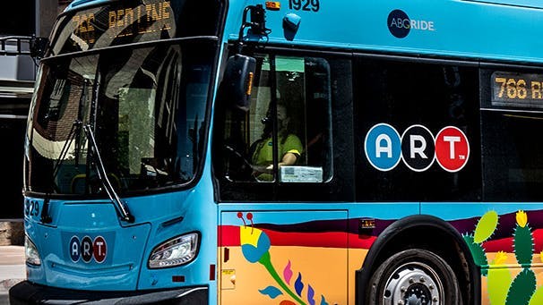 An ABQ Ride bus waits at the curb.