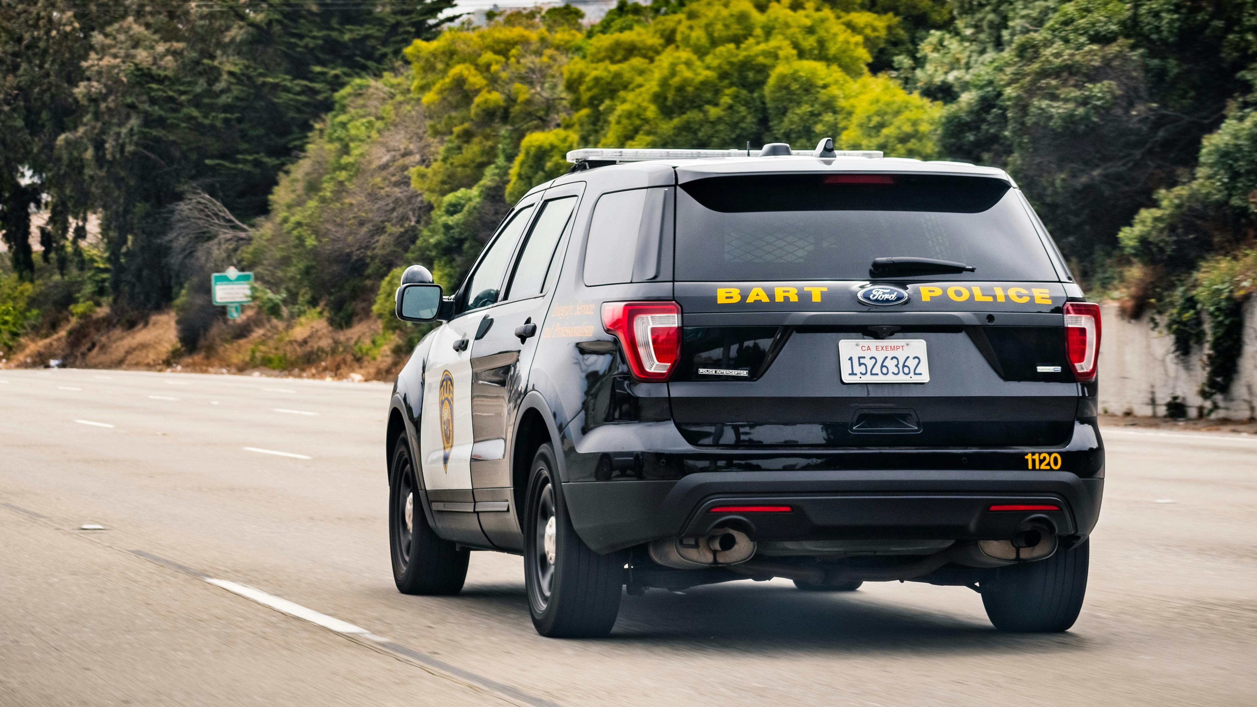 A BART PD cruiser drives away from the camera.