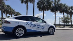 A Freebee branded Tesla Model X drives through the frame. A Freebee branded Tesla Model X drives through the frame.