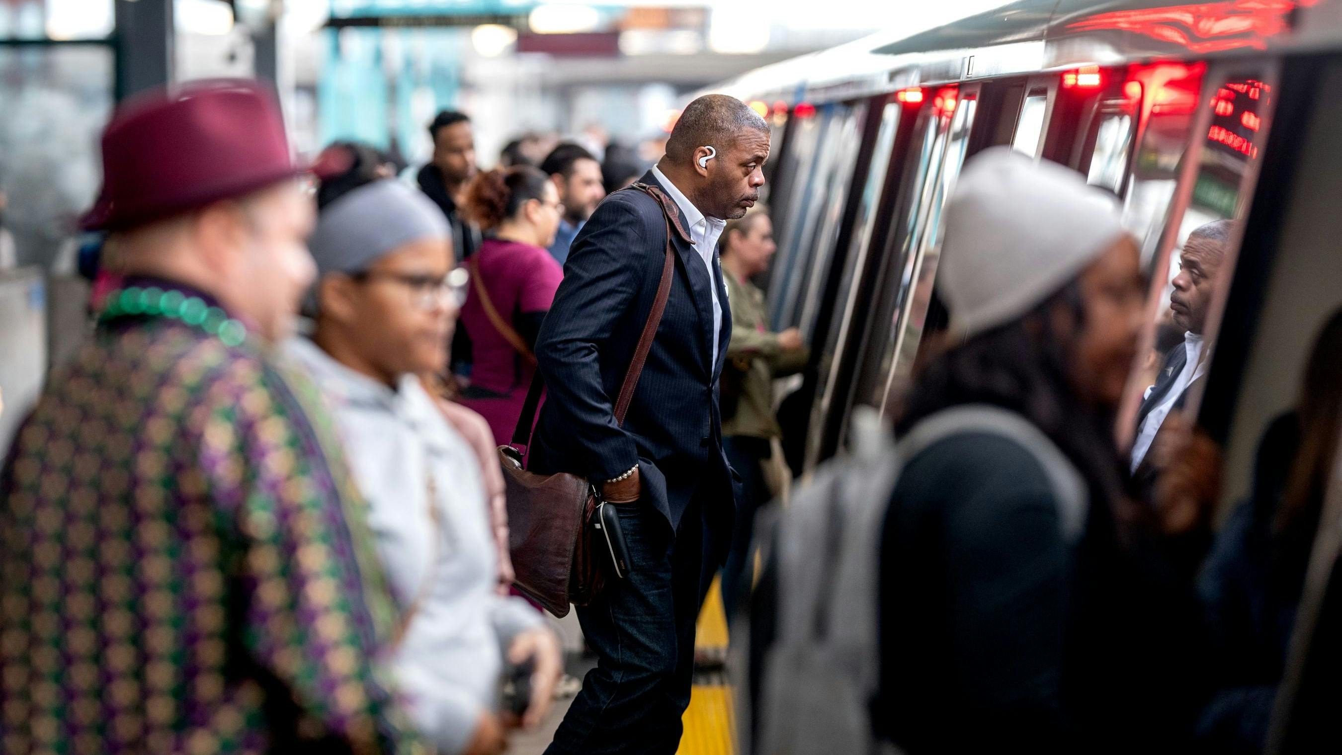 Passengers board a rail car.