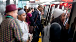 Passengers board a rail car.