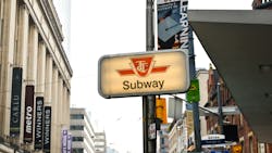 A TTC subway sign rests on a pole. A TTC subway sign rests on a pole.