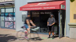 A cyclist rides past a pedestrian.