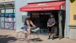 A cyclist rides past a pedestrian. A cyclist rides past a pedestrian.