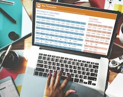 hand typing on laptop with screen that shows bus schedule time table hand typing on laptop with screen that shows bus schedule time table