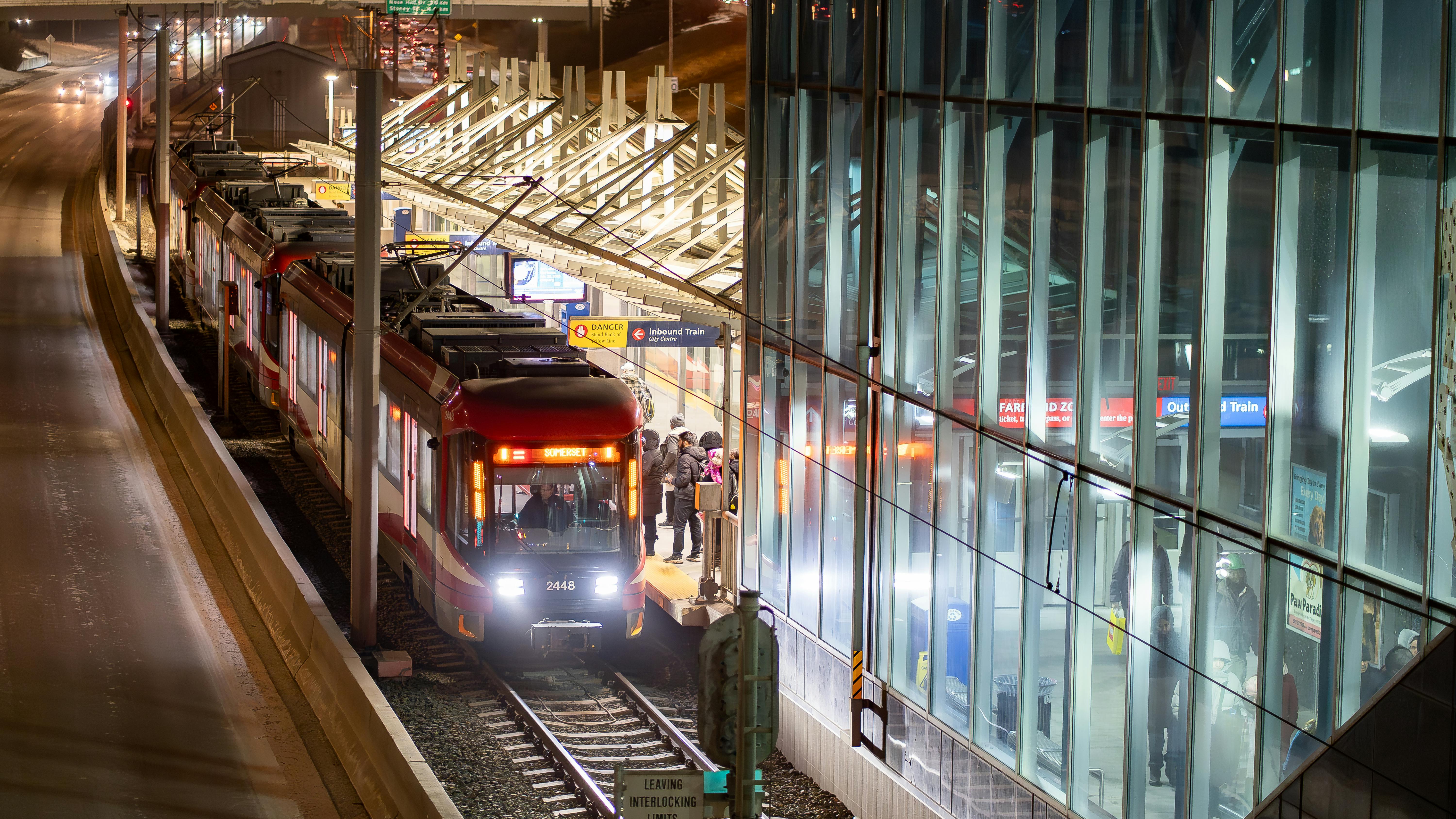 A CTrain picks up passengers at a station.