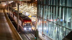 A CTrain picks up passengers at a station. A CTrain picks up passengers at a station.