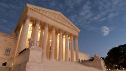 The image shows the U.S. Supreme Court building in the evening. The image shows the U.S. Supreme Court building in the evening.