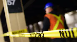 The image shows a blurred construction worker conducting work in the 57th Street station.