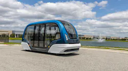 An Oceaneering autonomous vehicle sits parked near water.