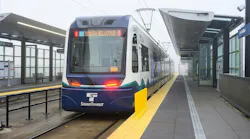 A Sound Transit rail vehicle pulls away from a station.