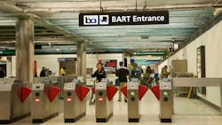 The image shows the old fare gates at a BART station enterance. The image shows the old fare gates at a BART station enterance.