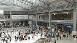 Passengers mill about Moynihan Train Hall.