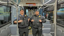 Two ABQ Ride TSOs stand inside a bus. Two ABQ Ride TSOs stand inside a bus.