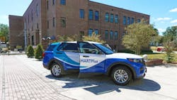The image shows a parked 2025 Ford Interceptor Utility model with its passenger door open. The image shows a parked 2025 Ford Interceptor Utility model with its passenger door open.