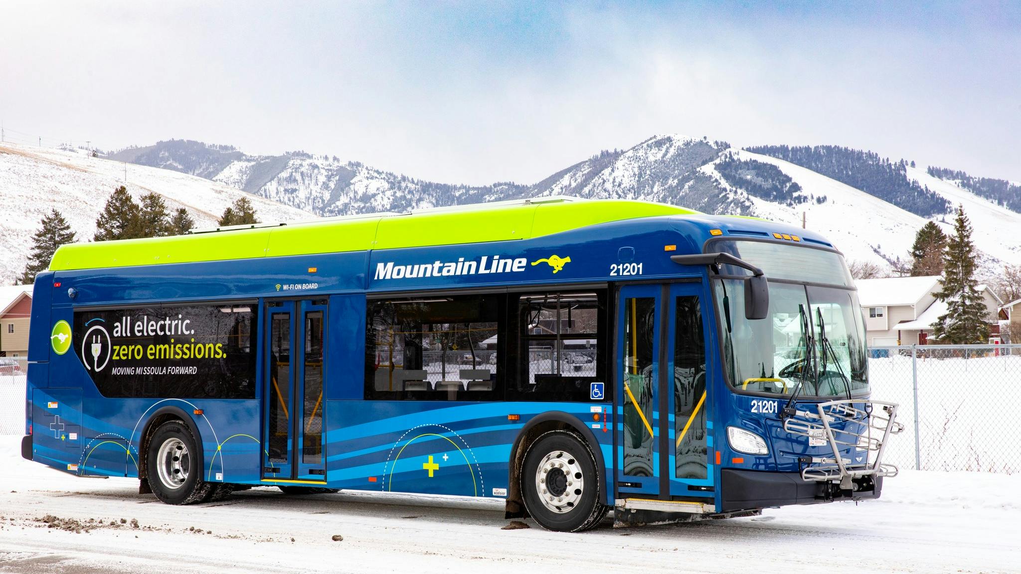 The image shows a Mountain Line bus parked in a snowy area.