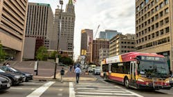 Traffic and pedestrians in downtown Baltimore near the city center. Traffic and pedestrians in downtown Baltimore near the city center.