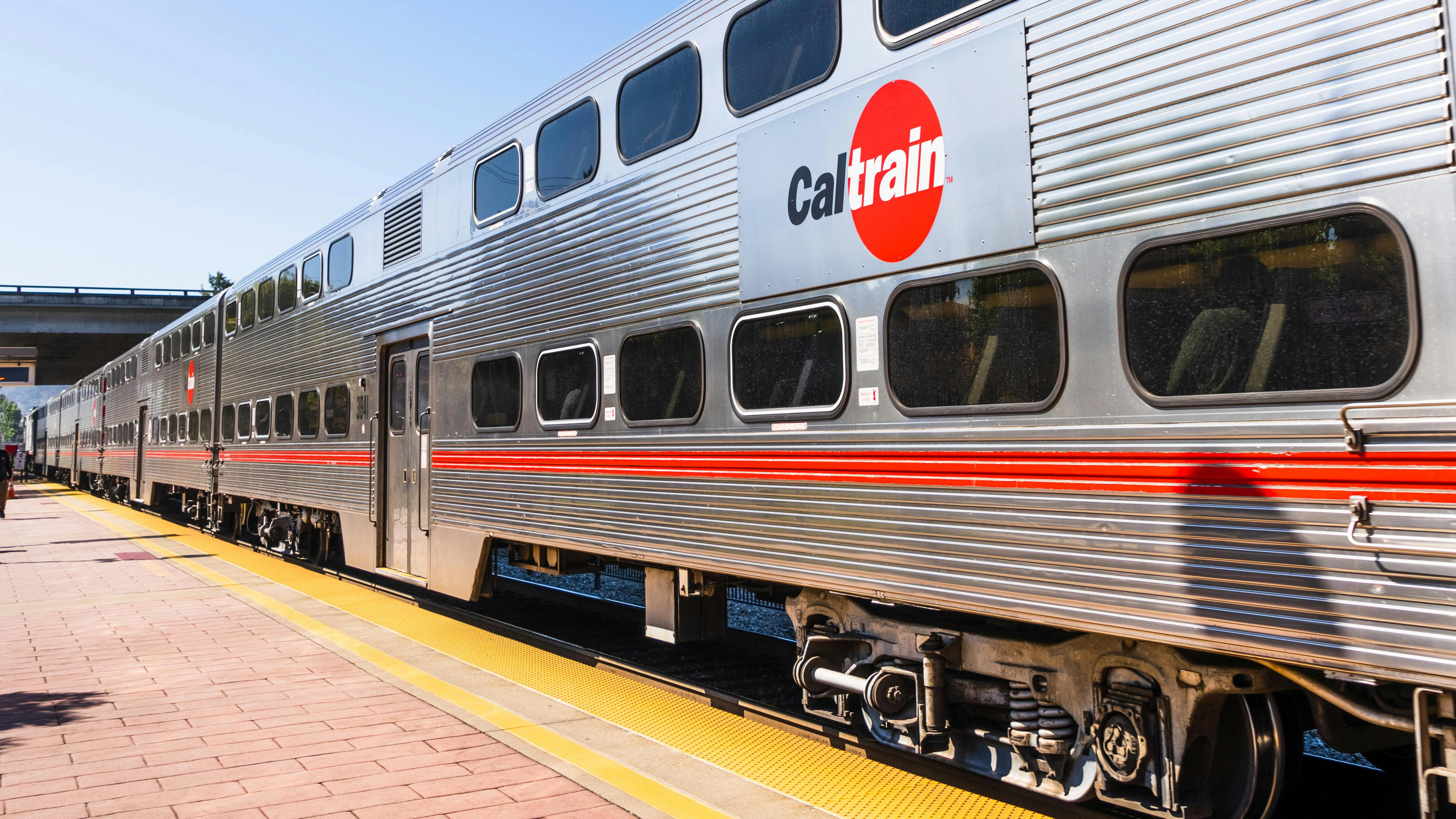 A Caltrain train car sits at a station.